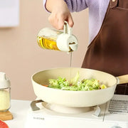 "Kitchen oil spray bottle for even and controlled oil distribution, perfect for cooking with less mess and waste."

